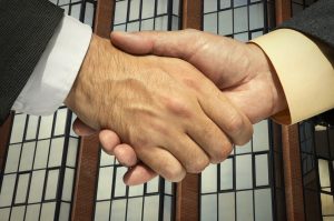 handshake behind a corporative building.Great for any design.