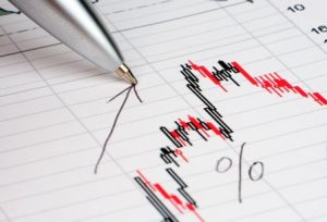 Pen showing diagram on financial report/magazine