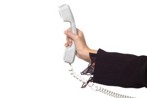 woman's hand with a phone receiver