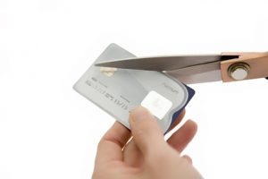 Debt concept - cutting a credit card